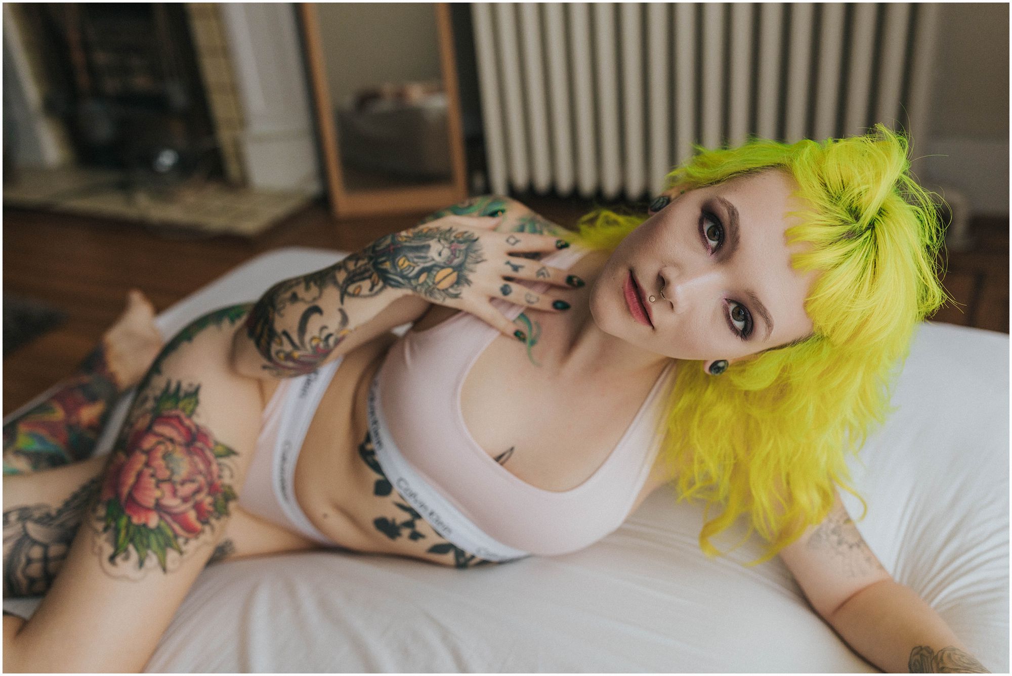 stunning alternative model with tattoos and medusa piercing during session with vancouver boudoir photographer