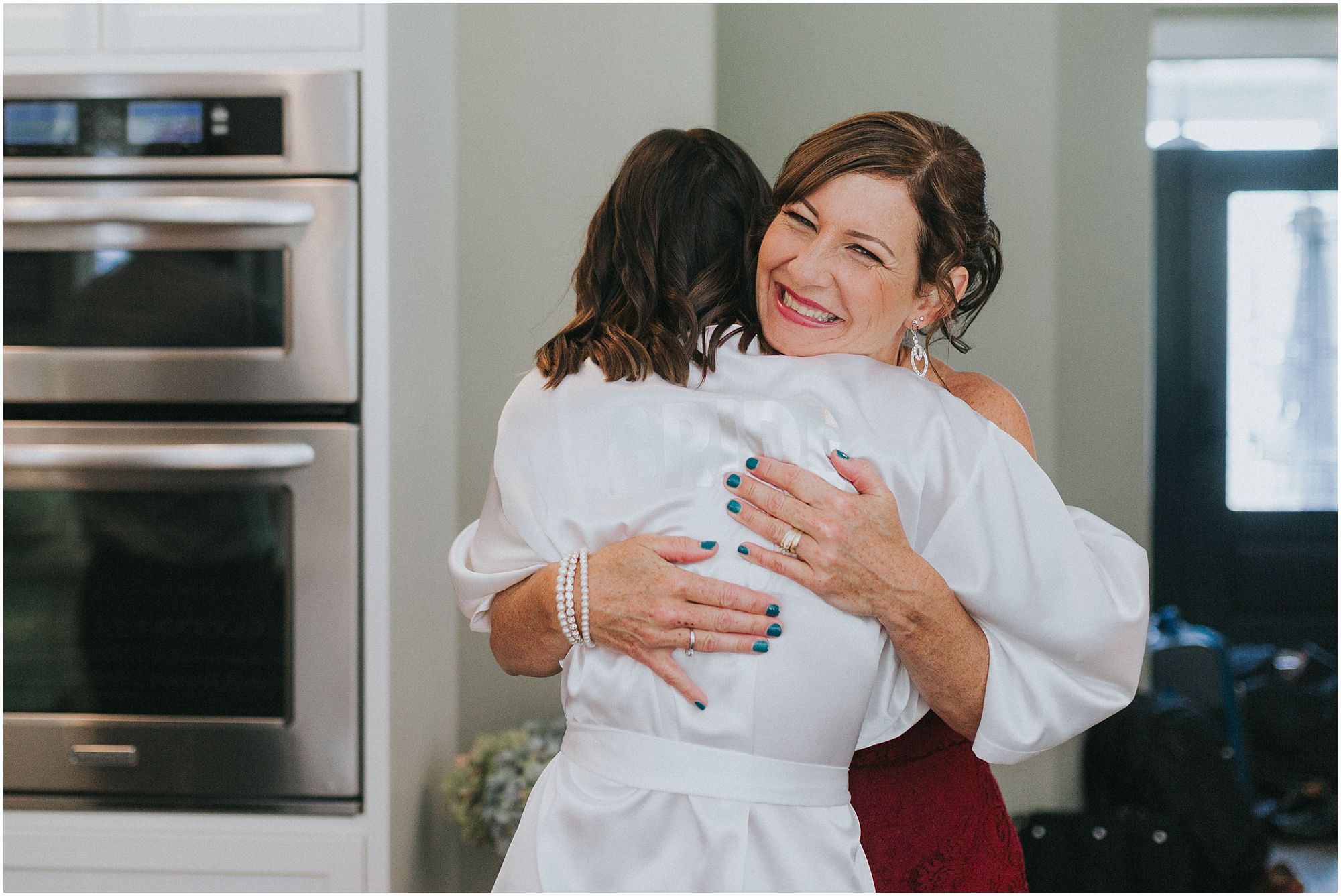 bride and her mom sharing an embrace