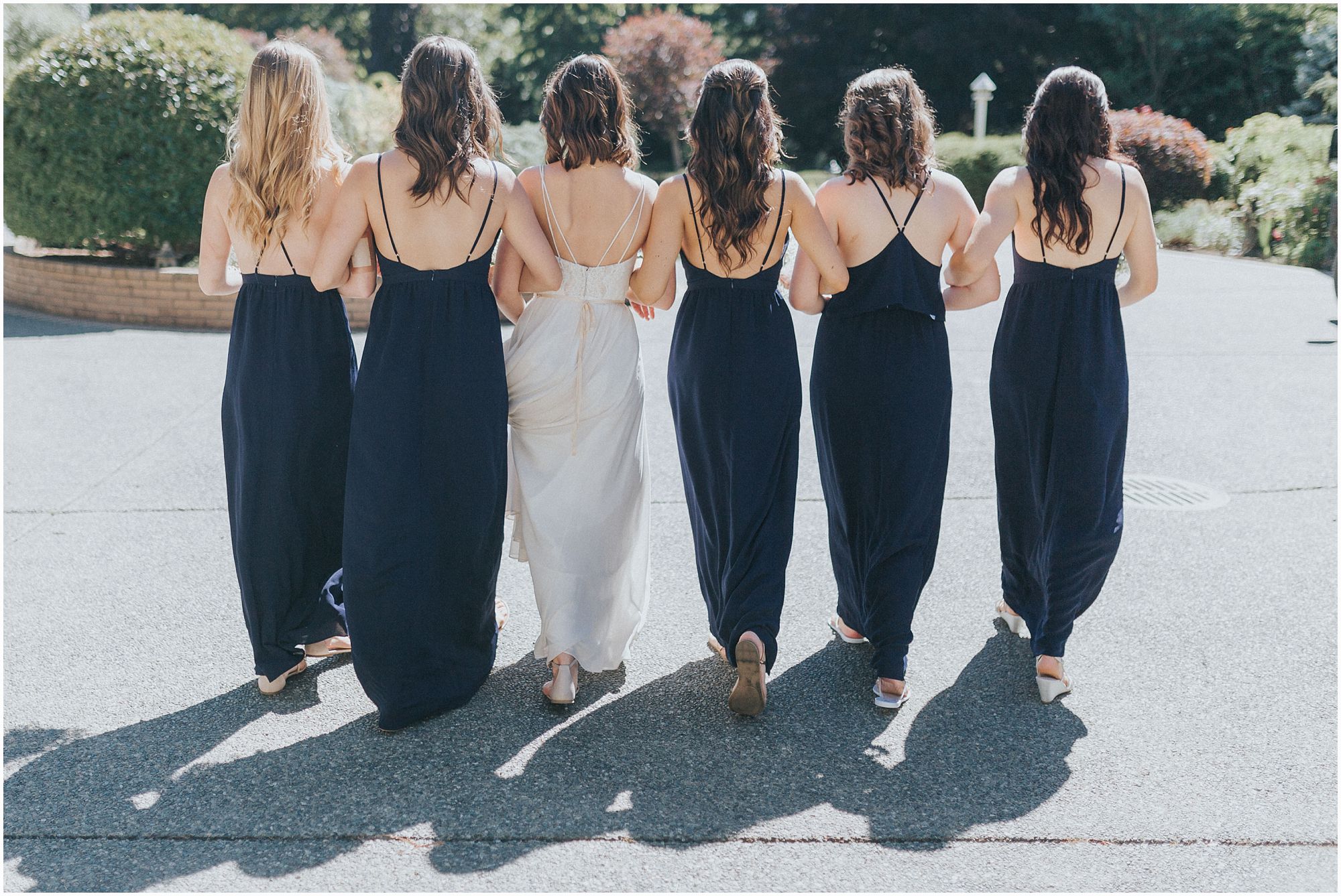 group of bridesmaids walking away 