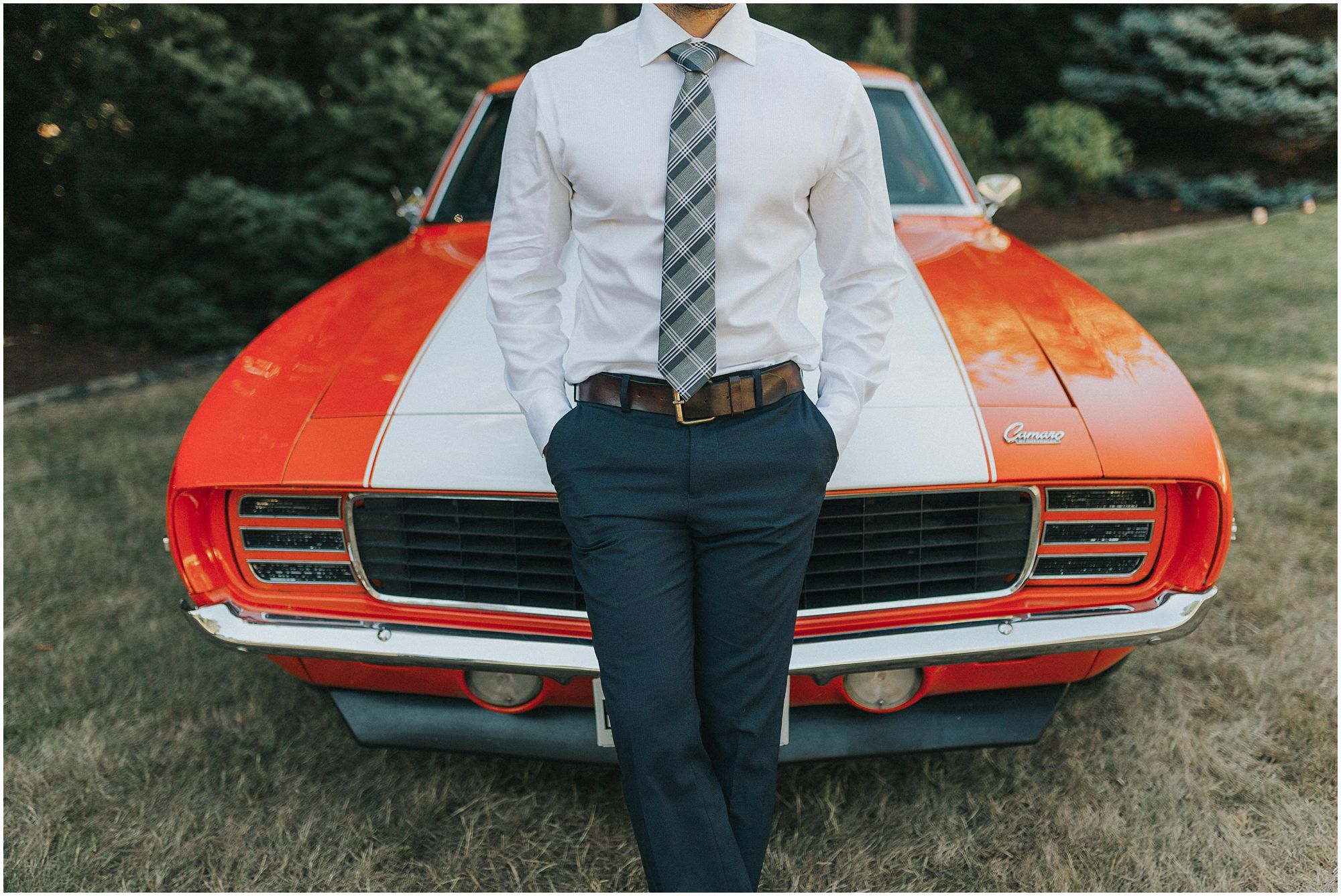 handsome groom posing with old classic mustang 